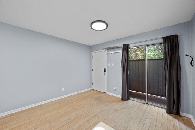 Empty room with baseboards and wood finished floors | Image 5