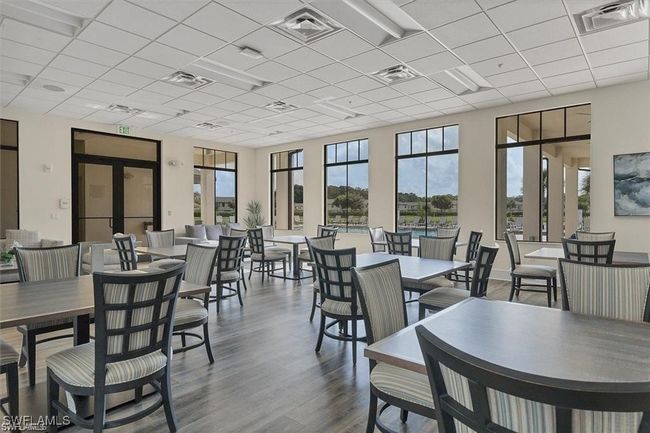 Dining area featuring plenty of natural light, a drop ceiling, and dark wood-style flooring | Image 23