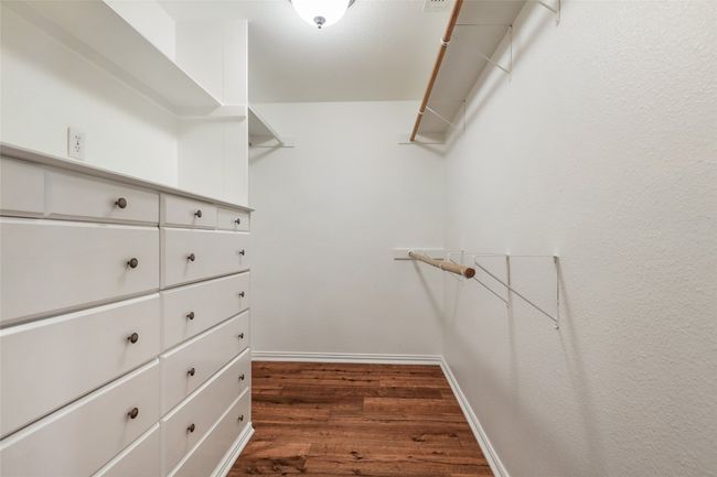 Walk in closet with dark wood-style flooring | Image 24