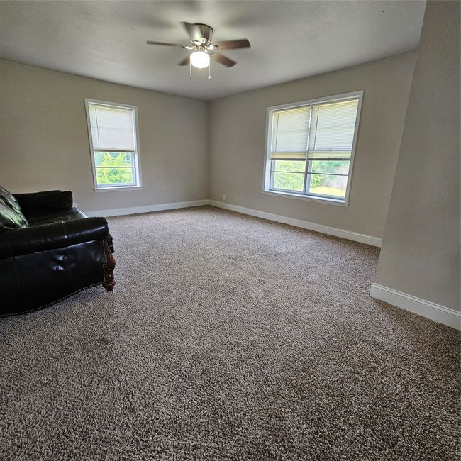 2nd Living area with plenty of natural light, a ceiling fan, carpet, and baseboards | Image 12