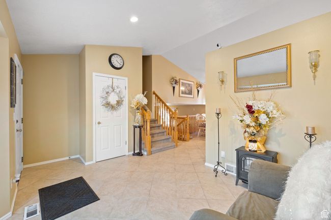 Entryway with light tile patterned flooring and lofted ceiling | Image 5
