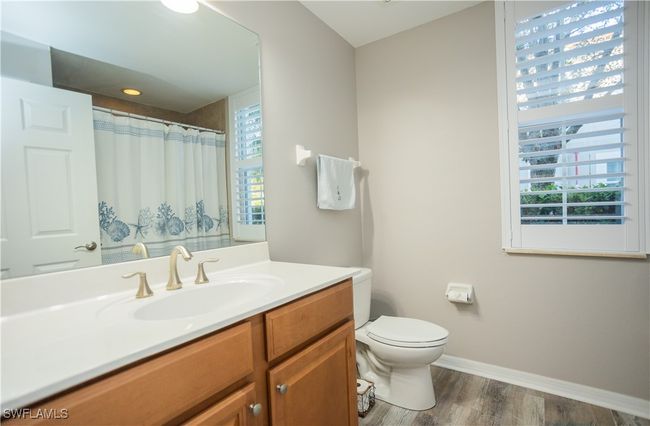 Bathroom featuring a healthy amount of sunlight, toilet, vinyl wood finished floors, and vanity | Image 11