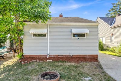 View of side of home with an outdoor fire pit | Image 3