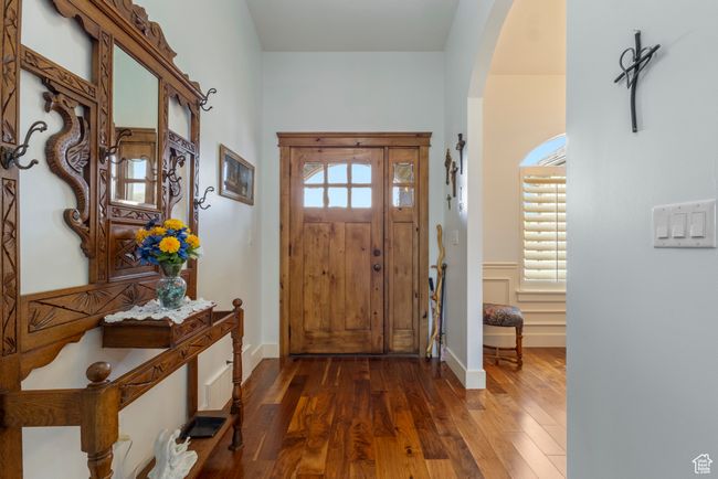 Foyer featuring arched walkways and dark wood finished floors | Image 10