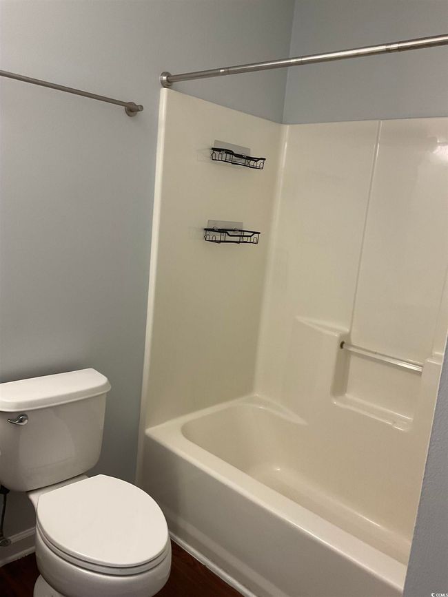 Full bath featuring wood finished floors and shower / bathtub combination | Image 10