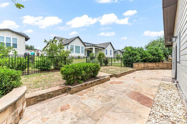 Fenced backyard featuring a patio area and a residential view | Image 13