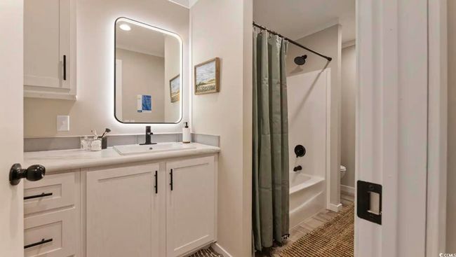 Bathroom with vanity, shower / bath combo, and toilet | Image 32