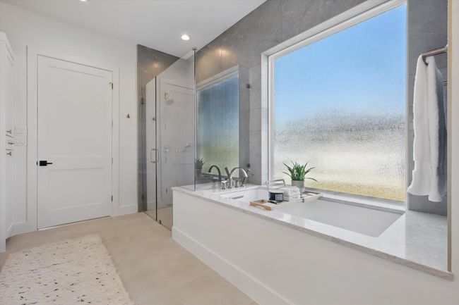 Full bathroom featuring recessed lighting, a stall shower, and a soaking tub | Image 19