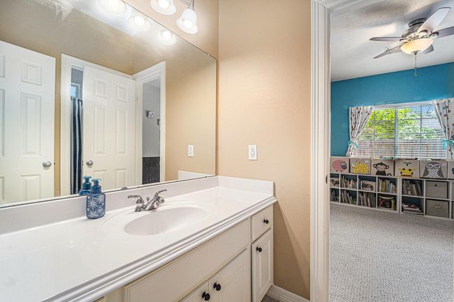 Secondary bathroom with lots of countertop and cabinet space and a combination tub and shower. | Image 20