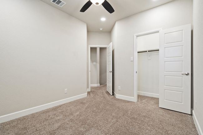 Unfurnished bedroom with light colored carpet, a closet, and ceiling fan | Image 20
