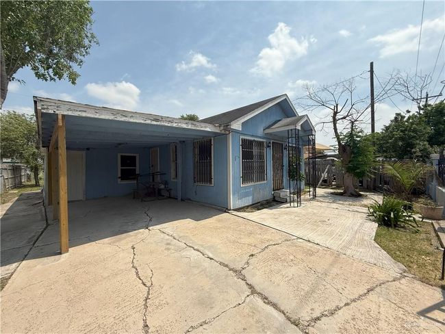 Back of house with fence, driveway, and a carport | Image 32