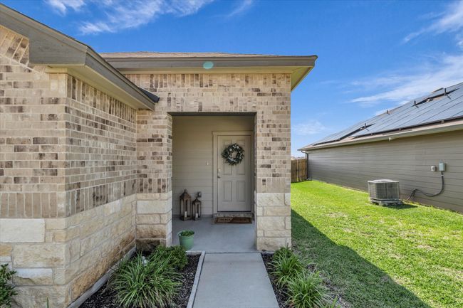 Property entrance featuring cooling unit and brick siding | Image 5
