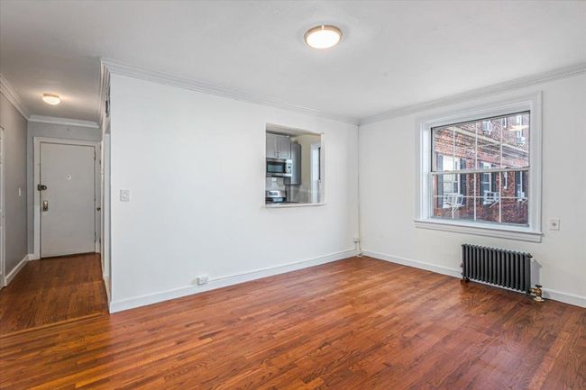 Living Room featuring crown molding, and dark wood-type flooring | Image 4