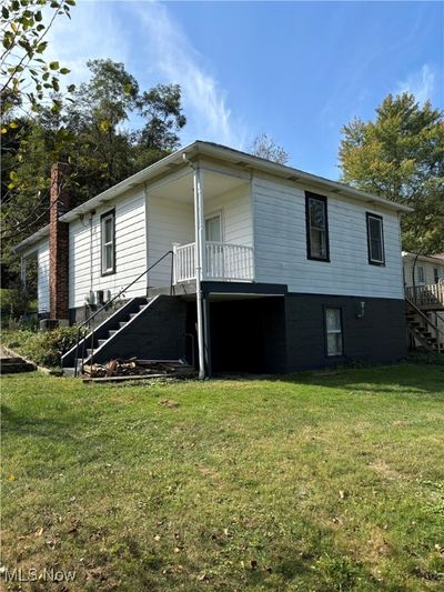 View of front of home featuring a front yard and a deck | Image 3