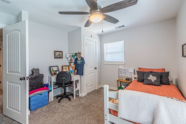Bedroom with carpet flooring and a ceiling fan | Image 28