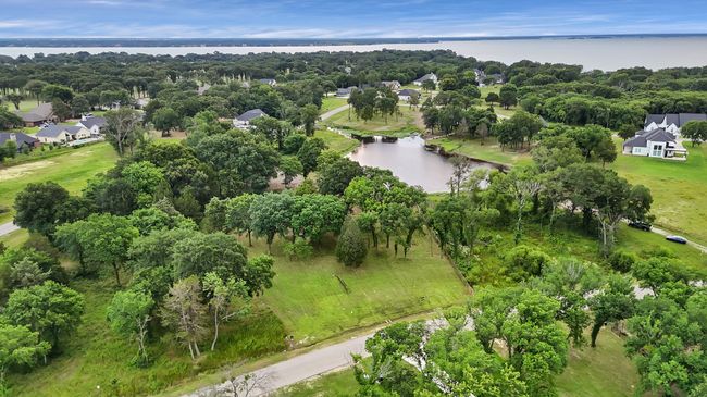 Aerial overview of property's location with a large body of water and nearby suburban area | Image 10