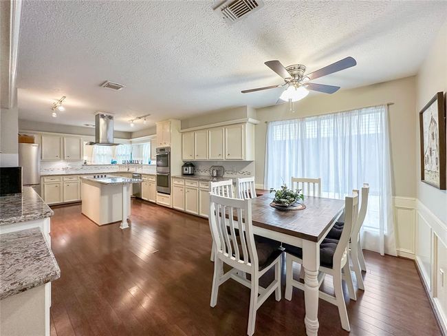 Large windows invite an abundance of natural light, creating warmth and more charm. | Image 9