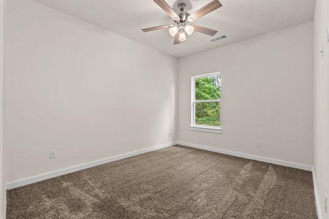 Bedroom featuring carpet floors, baseboards, and ceiling fan | Image 29