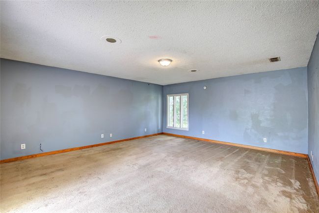 Empty room featuring carpet, baseboards, and a textured ceiling | Image 13