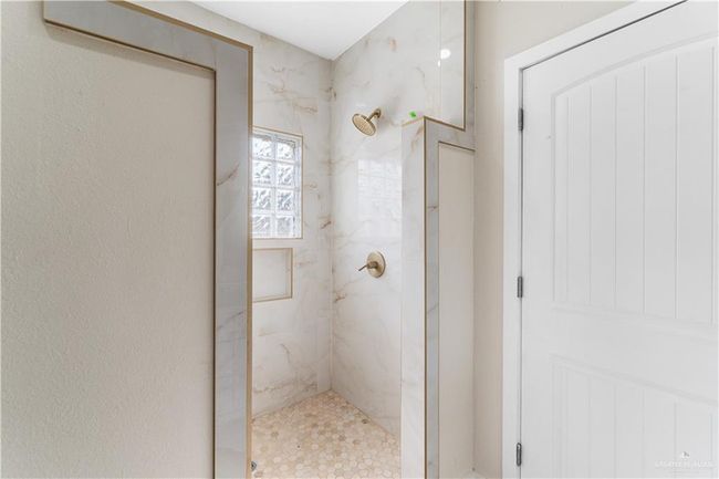 Bathroom featuring tiled shower | Image 10