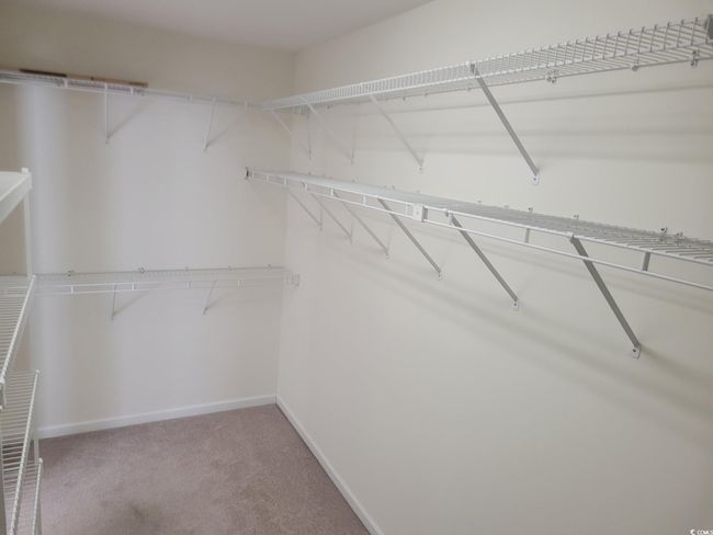 Walk in closet with carpet flooring | Image 14