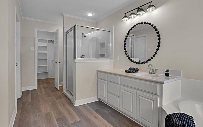 Primary bath featuring 2 spacious closets, wood finished floors, seperate shower and 2 vanities | Image 25