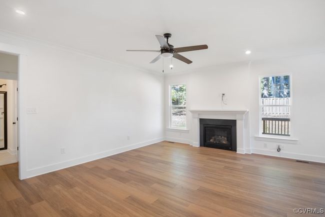 Photo represents the plan, not the actual home. Design selections may vary. A spacious kitchen with an island and pantry open to an adjoining dining area and the family room. | Image 17