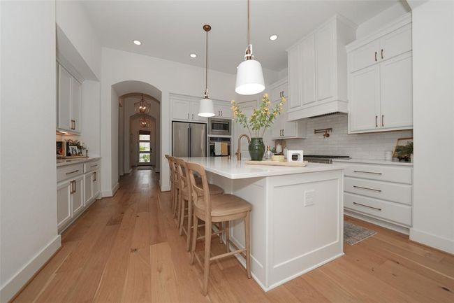Expansive island with elegant custom lighting. | Image 5