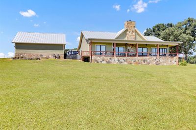 Rear view of property with a yard and a porch | Image 1