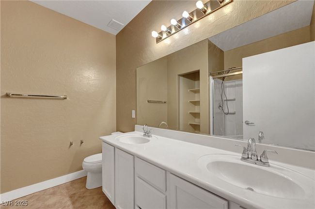 Bathroom featuring baseboards, toilet, a shower, and a sink | Image 17