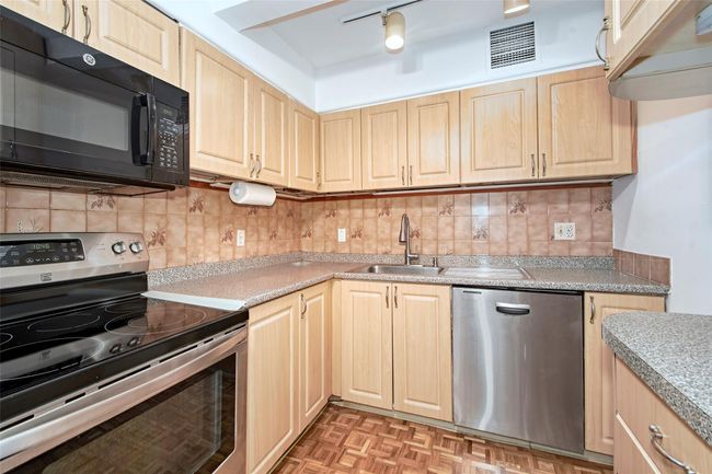 Kitchen featuring appliances with stainless steel finishes, light brown cabinets, and light countertops | Image 17