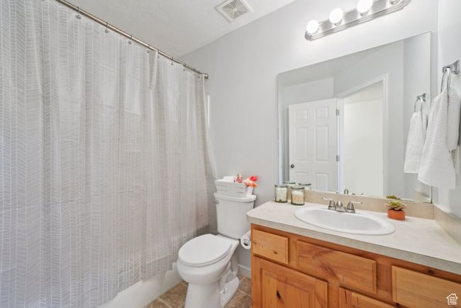 Full bathroom with vanity, tile patterned flooring, and shower. | Image 13