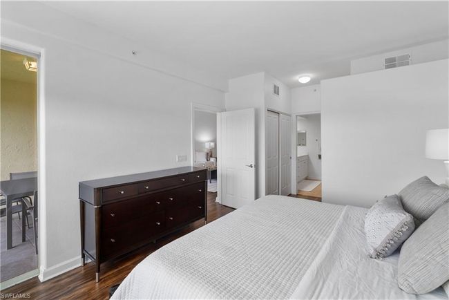 Main bedroom featuring a closet, connected bathroom, and dark hardwood / wood-style flooring | Image 10
