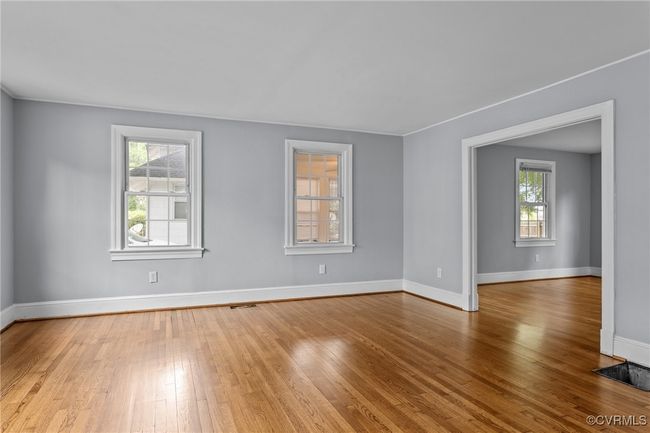 Empty room featuring light wood-style floors, visible vents, and baseboards | Image 4