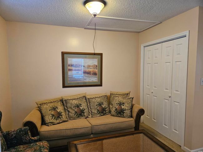 Living room featuring attic access and a textured ceiling | Image 22