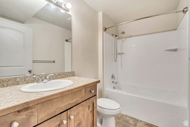 Bathroom with shower / tub combination, vanity, and tile patterned flooring | Image 16