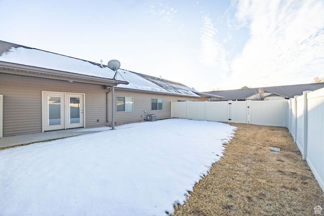 Yard layered in snow with central AC unit | Image 15
