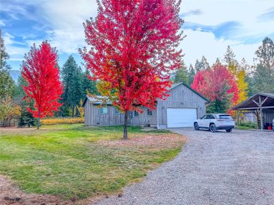 View of front of property featuring a carport, a garage, and a front yard | Image 2