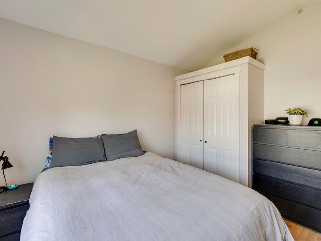 Bedroom featuring lofted ceiling, wood finished floors, and a closet | Image 26