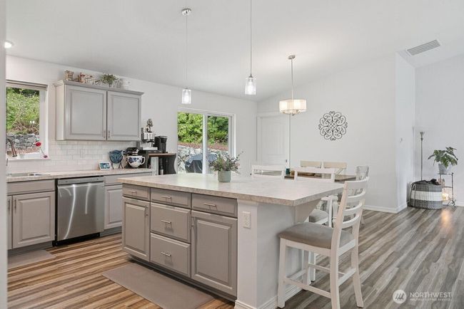 Kitchen is light and open to living room and dining area. | Image 6