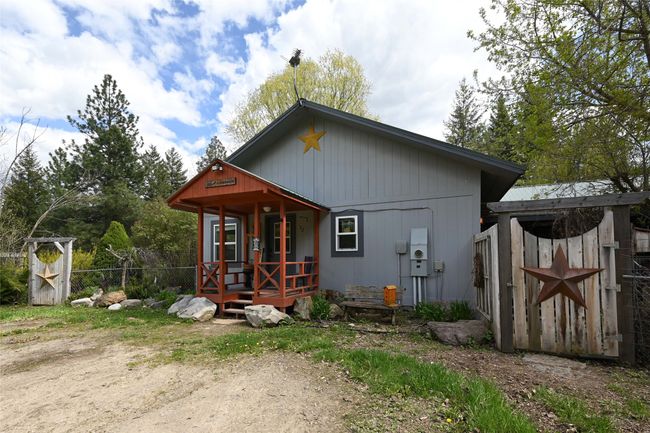 Rear view of property featuring fence and a porch | Image 9