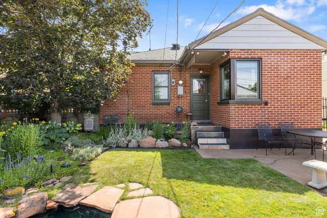 View of front of house featuring brick siding, a front yard, and a patio area | Image 23