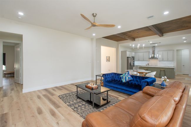 Living room with beamed ceiling, light hardwood / wood-style floors, ceiling fan, and wooden ceiling | Image 19
