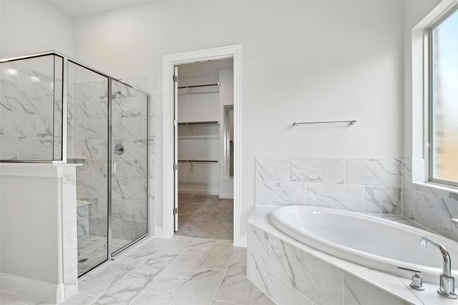 Bathroom with a shower stall, a bath, a walk in closet, and marble finish floors | Image 21