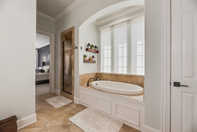 Primary Bathroom with crown molding, a garden tub, a stall shower, tile patterned floors, and connected bathroom | Image 11