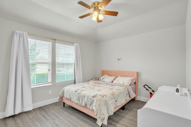 Bedroom featuring wood finished floors and ceiling fan | Image 19
