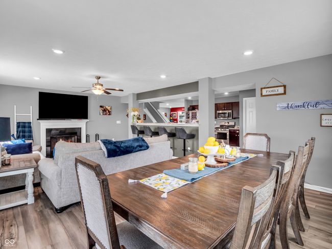 dining space with recessed lighting, a ceiling fan, a glass covered fireplace, and light vinyl plank floors | Image 12