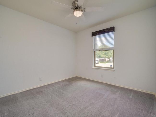 Third bedroom with carpet flooring and a ceiling fan. | Image 21