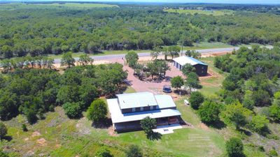 Aerial View of Primary Residence and Workshop with 50 acres. View of Entrance of FM 209 with electric gate, circular driveway and easy access to Workshop | Image 1