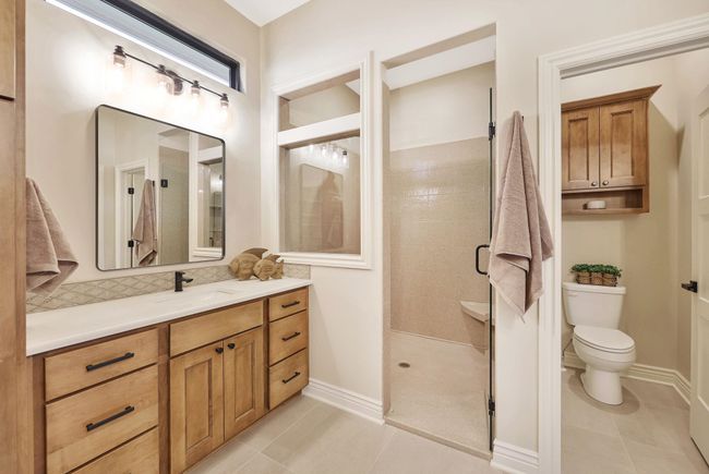 Bathroom featuring vanity, toilet, an enclosed shower, and tile patterned floors | Image 23